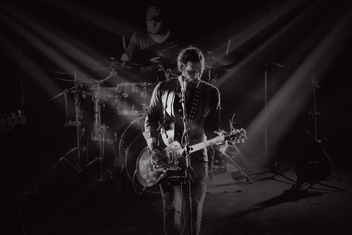 A band mid-performance under stage lighting