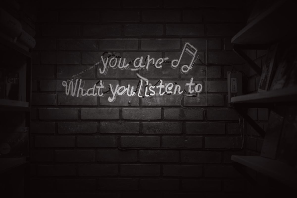 A neon sign reading you are what you listen to