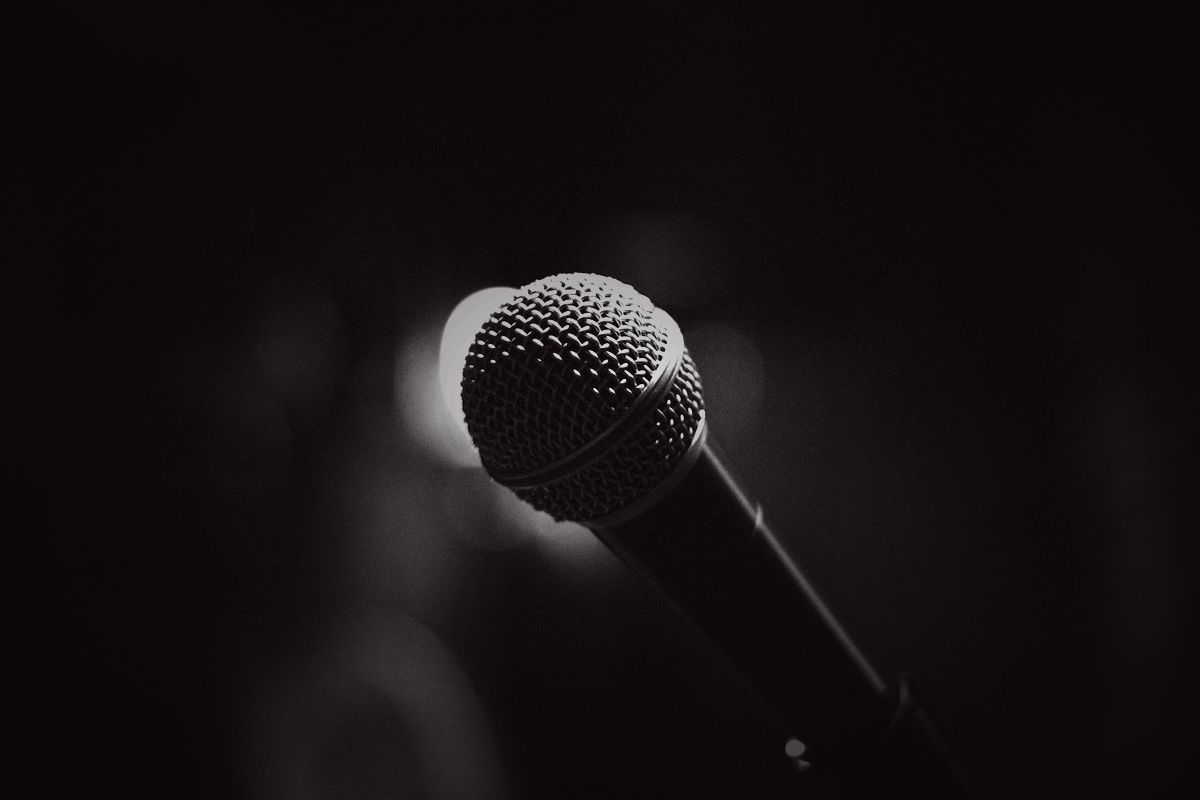 A microphone lit against a dark studio wall