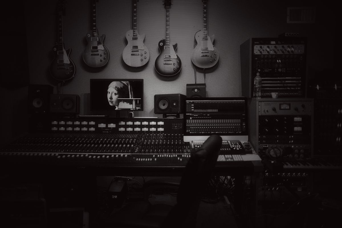 A recording studio with guitars racked along the wall
